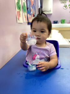 Waddler exploring a sensory activity at Loving Touch Nursery School