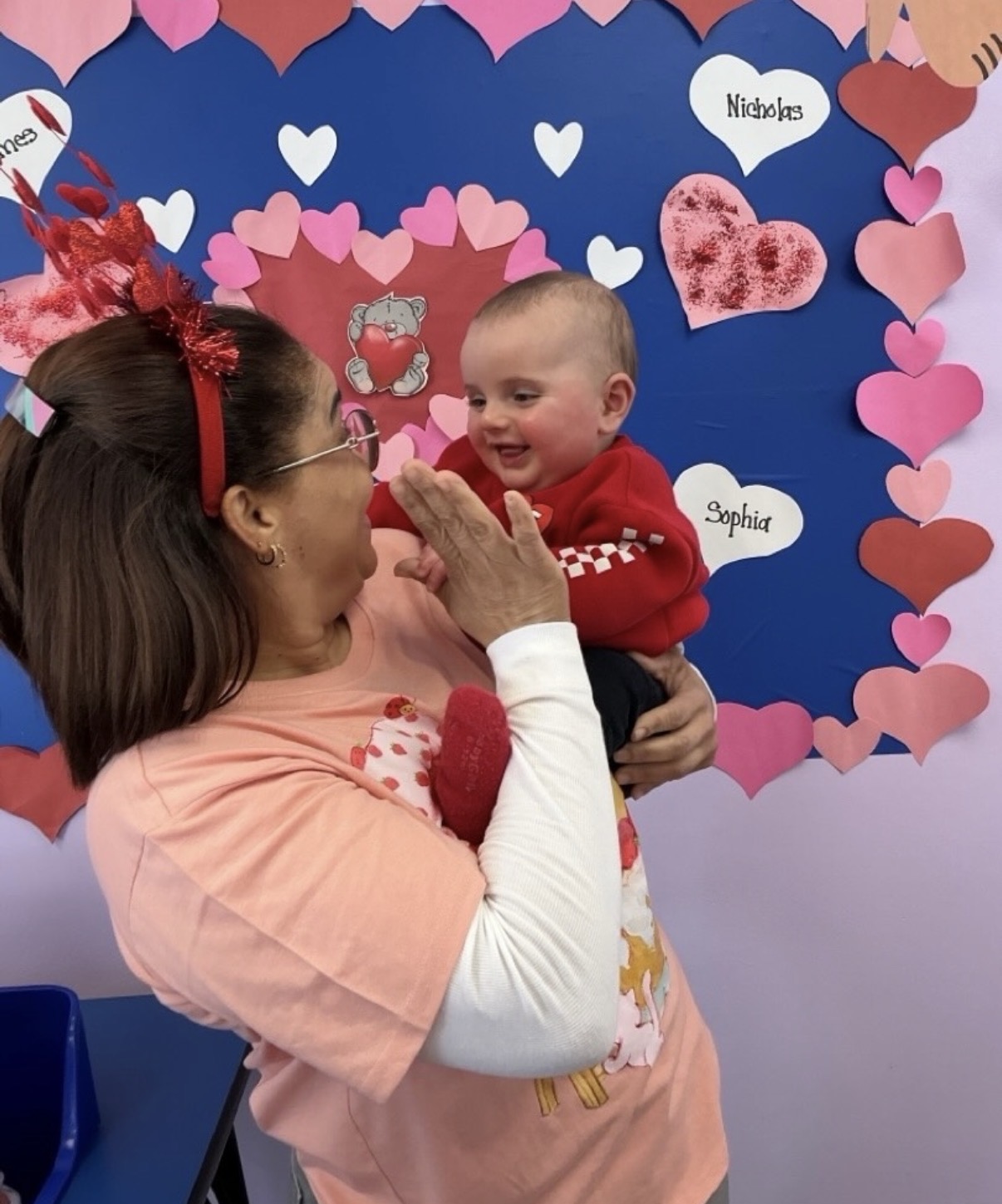 Loving Touch teacher caring for an infant in the classroom