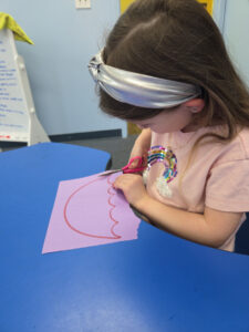 Pre-K child practicing fine motor skills at Loving Touch Nursery School